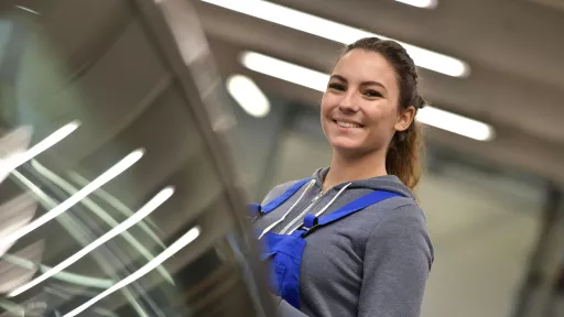 Portrait of apprentice standing in mechanics workshop