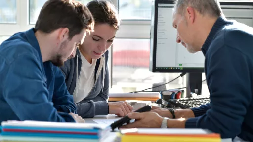 Young people in design office with instructor