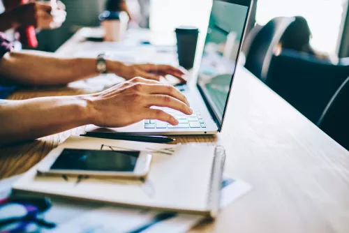 Cropped view of hands typing text on keyboard of modern laptop computer in search useful information on internet websites.Courses for IT professionals at digital netbook.Installing app on device